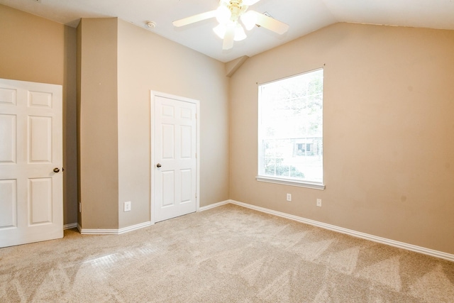 18002 Outback Lakes Trl, Humble, TX 77346 - unfurnished bedroom with carpet flooring, multiple windows, vaulted ceiling, and baseboards