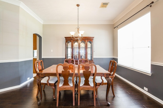 18002 Outback Lakes Trl, Humble, TX 77346 - dining space featuring arched walkways, dark wood-type flooring, a chandelier, ornamental molding, and baseboards