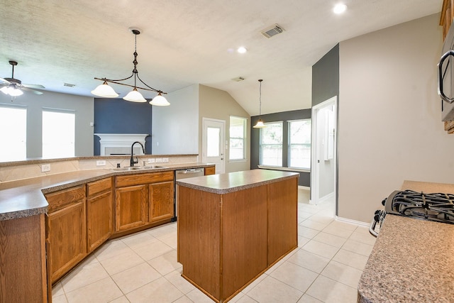 18002 Outback Lakes Trl, Humble, TX 77346 - kitchen with a sink, a kitchen island, stainless steel appliances, brown cabinets, and healthy amount of natural light