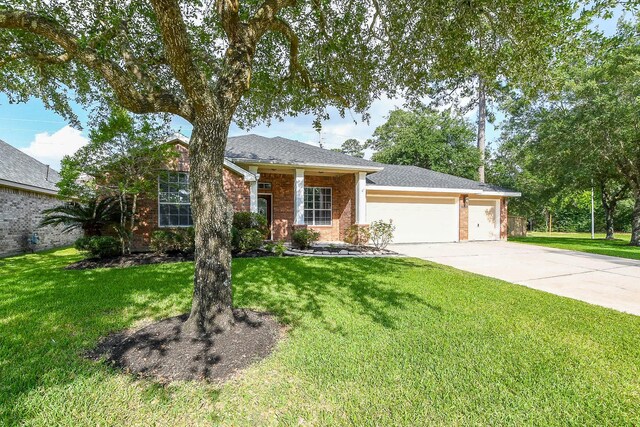18002 Outback Lakes Trl, Humble, TX 77346 - view of front of home featuring a garage, driveway, and a front yard