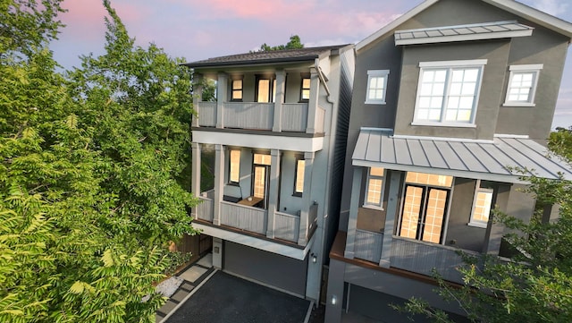 208 Aurora St Unit B, Houston, TX 77008 - view of front of house with a standing seam roof, metal roof, and a balcony