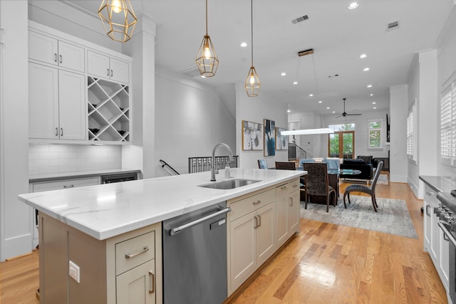 208 Aurora St Unit B, Houston, TX 77008 - kitchen with stainless steel dishwasher, a sink, light wood-style flooring, open floor plan, and recessed lighting