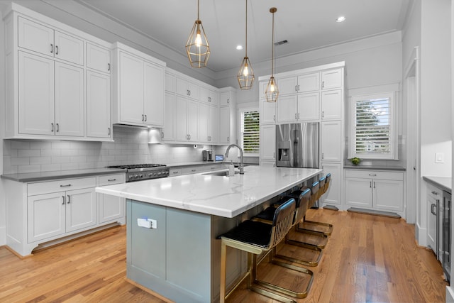 208 Aurora St Unit B, Houston, TX 77008 - kitchen with a sink, plenty of natural light, white cabinets, backsplash, and crown molding
