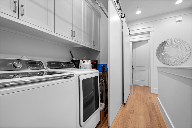 208 Aurora St Unit B, Houston, TX 77008 - washroom with light wood-style flooring, washer and dryer, a barn door, recessed lighting, and cabinet space