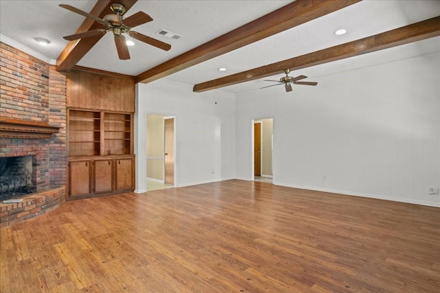 30814 Quinn Rd, Tomball, TX 77375 - unfurnished living room with ceiling fan, beam ceiling, a fireplace, light wood-style flooring, and baseboards