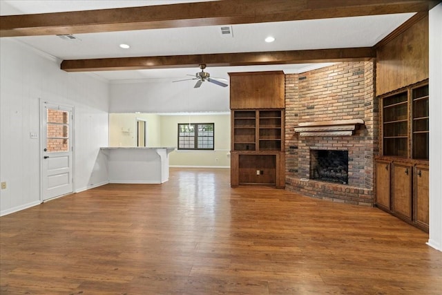 30814 Quinn Rd, Tomball, TX 77375 - unfurnished living room with beamed ceiling, a brick fireplace, ceiling fan, wood finished floors, and baseboards