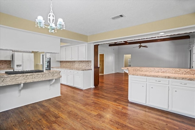 30814 Quinn Rd, Tomball, TX 77375 - kitchen with white refrigerator with ice dispenser, white cabinetry, tasteful backsplash, wall oven, and dark wood-style floors