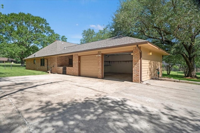 30814 Quinn Rd, Tomball, TX 77375 - view of home's exterior featuring brick siding, a garage, a yard, driveway, and a shingled roof