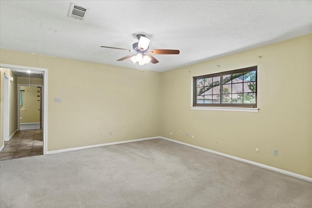30814 Quinn Rd, Tomball, TX 77375 - empty room featuring attic access, carpet, ceiling fan, baseboards, and a textured ceiling