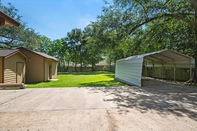 30814 Quinn Rd, Tomball, TX 77375 - view of patio featuring driveway, a carport, and an outbuilding