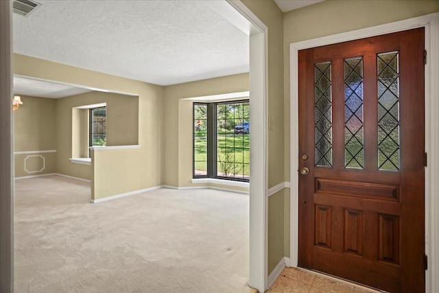 30814 Quinn Rd, Tomball, TX 77375 - entrance foyer with baseboards, carpet floors, and a textured ceiling
