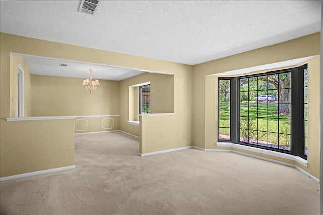 30814 Quinn Rd, Tomball, TX 77375 - carpeted empty room featuring a chandelier, baseboards, and a textured ceiling