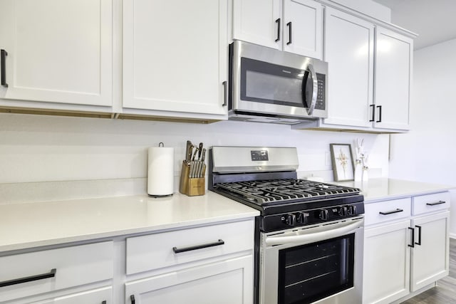 1386 Antigua Dr, Conroe, TX 77301 - kitchen featuring stainless steel appliances, light countertops, and white cabinets