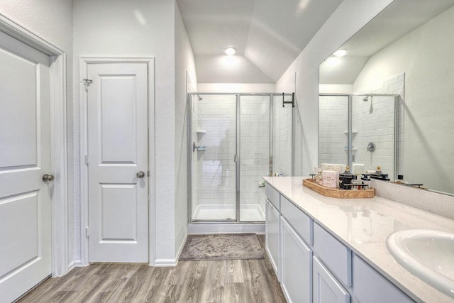 1386 Antigua Dr, Conroe, TX 77301 - full bathroom with wood finished floors, a shower stall, vanity, and lofted ceiling