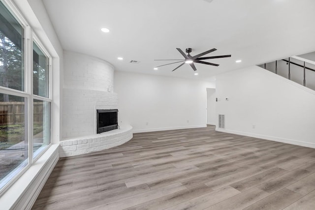 9602 Ballin David Dr, Spring, TX 77379 - unfurnished living room with a ceiling fan, wood finished floors, plenty of natural light, a fireplace, and recessed lighting
