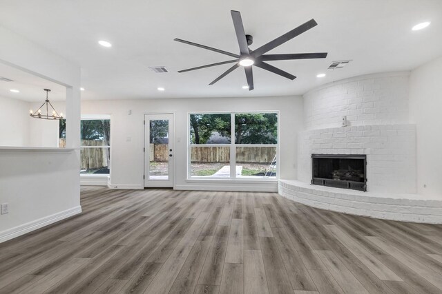9602 Ballin David Dr, Spring, TX 77379 - unfurnished living room featuring a ceiling fan, wood finished floors, a brick fireplace, plenty of natural light, and recessed lighting