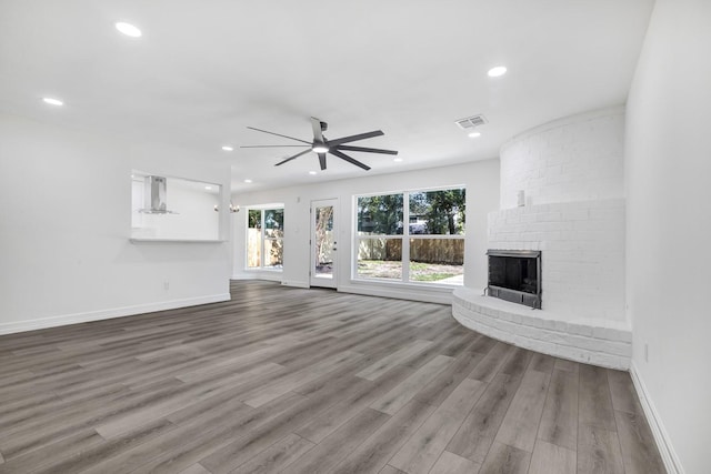 9602 Ballin David Dr, Spring, TX 77379 - unfurnished living room with a ceiling fan, wood finished floors, a fireplace, baseboards, and recessed lighting