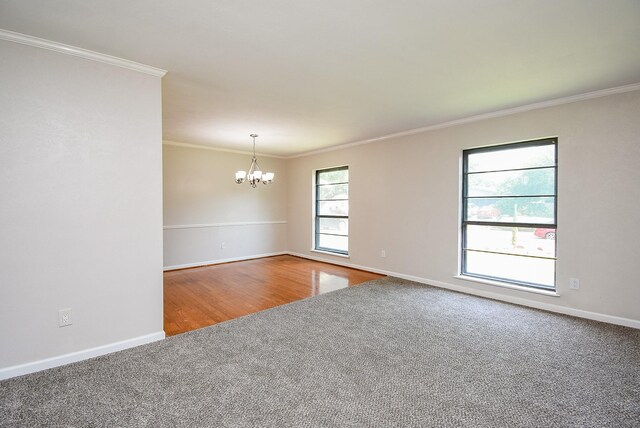 16806 Grampin Dr, Houston, TX 77084 - carpeted spare room with a chandelier, ornamental molding, baseboards, and wood finished floors