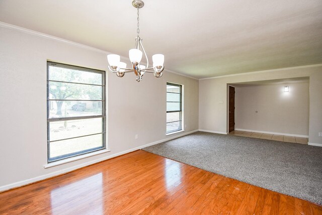 16806 Grampin Dr, Houston, TX 77084 - empty room featuring crown molding, a chandelier, healthy amount of natural light, baseboards, and wood finished floors