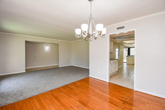 16806 Grampin Dr, Houston, TX 77084 - empty room with a chandelier, crown molding, light wood-type flooring, and baseboards
