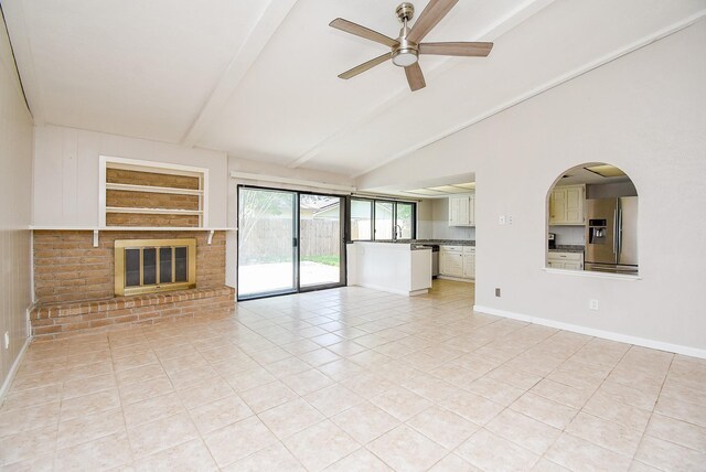 16806 Grampin Dr, Houston, TX 77084 - unfurnished living room with light tile patterned floors, ceiling fan, a brick fireplace, and a sink