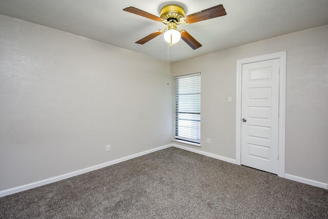 16806 Grampin Dr, Houston, TX 77084 - empty room with dark colored carpet, a ceiling fan, and baseboards