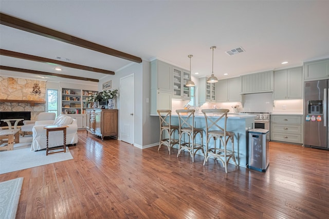 2211 Wycliffe Dr, Houston, TX 77043 - kitchen with appliances with stainless steel finishes, a breakfast bar area, glass insert cabinets, a peninsula, and gray cabinets