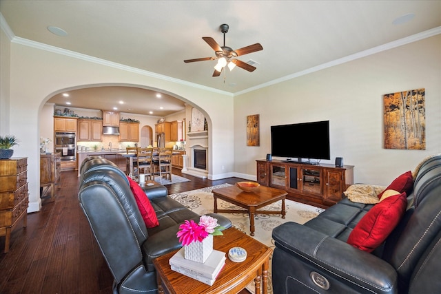 5131 Anthony Springs Ln, Sugar Land, TX 77479 - living area with arched walkways, dark wood finished floors, ceiling fan, baseboards, and crown molding