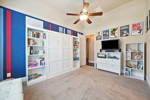 5131 Anthony Springs Ln, Sugar Land, TX 77479 - rec room with carpet flooring, ceiling fan, arched walkways, and a high ceiling