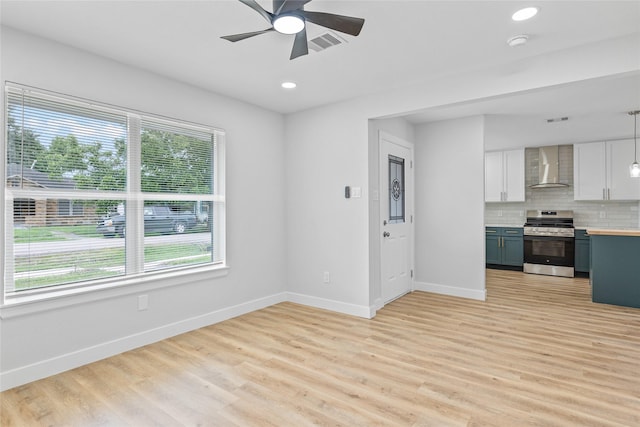 5115 Clay St, Houston, TX 77023 - unfurnished living room with baseboards, light wood-type flooring, ceiling fan, and recessed lighting