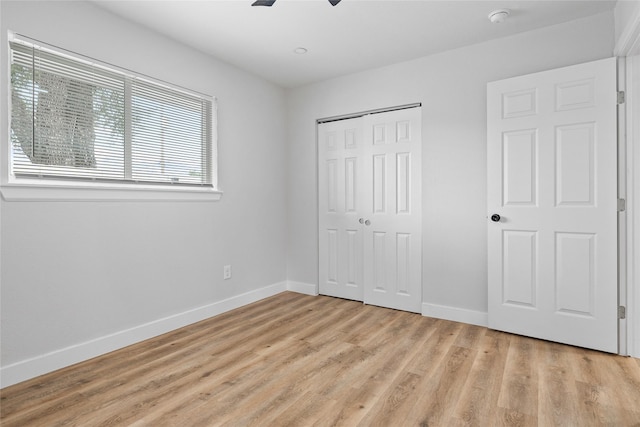 5115 Clay St, Houston, TX 77023 - unfurnished bedroom with baseboards, light wood-style floors, a closet, and ceiling fan