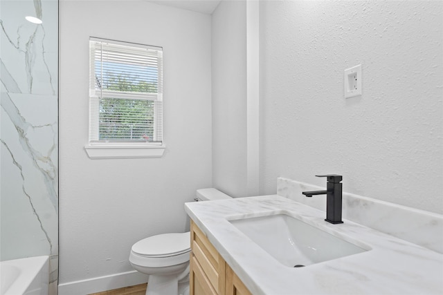 5115 Clay St, Houston, TX 77023 - full bath with vanity, toilet, wood finished floors, and baseboards
