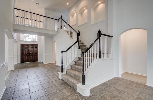 24206 Moon Ridge Ct, Katy, TX 77494 - entryway with arched walkways, a high ceiling, stairway, baseboards, and recessed lighting
