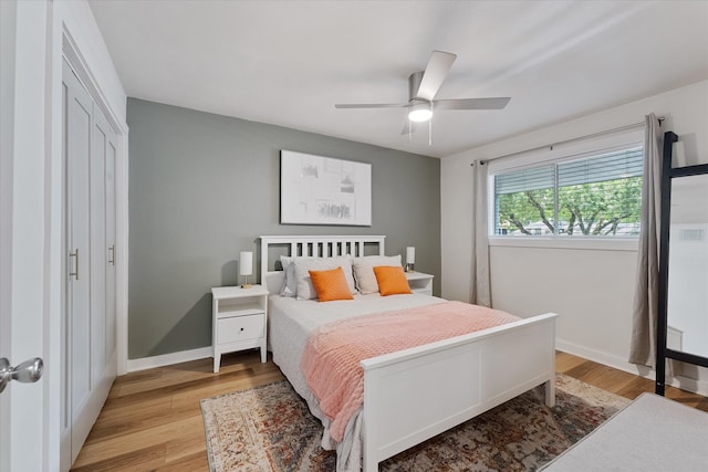 12500 Melville Dr Unit 218B, Montgomery, TX 77356 - bedroom featuring baseboards, light wood-type flooring, a ceiling fan, and a closet