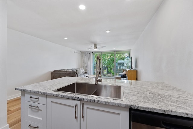 12500 Melville Dr Unit 218B, Montgomery, TX 77356 - kitchen with a sink, dishwasher, open floor plan, light stone countertops, and recessed lighting