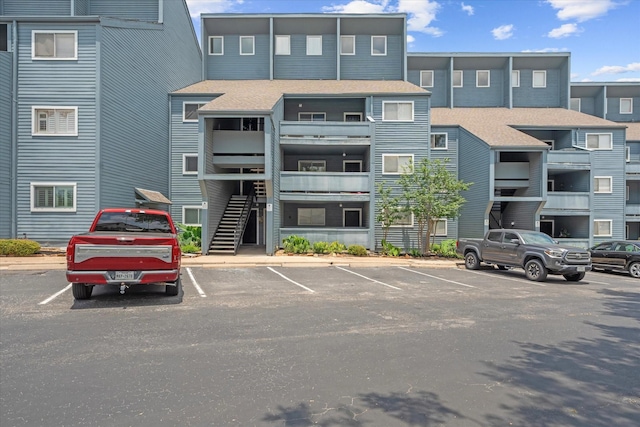 12500 Melville Dr Unit 218B, Montgomery, TX 77356 - view of building exterior with uncovered parking and stairway
