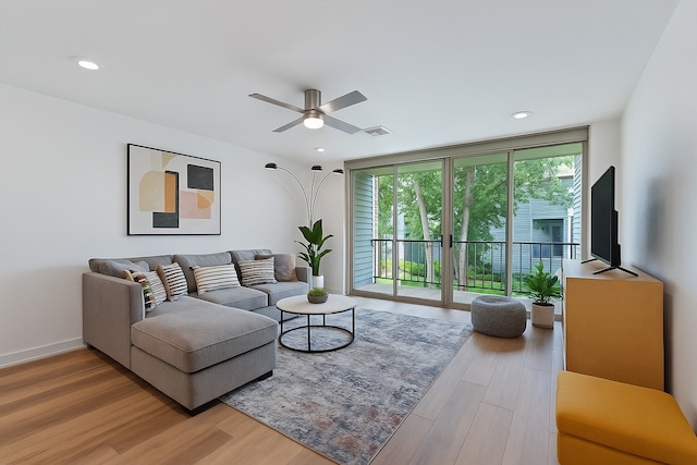 12500 Melville Dr Unit 218B, Montgomery, TX 77356 - living room with wood finished floors, ceiling fan, recessed lighting, and baseboards