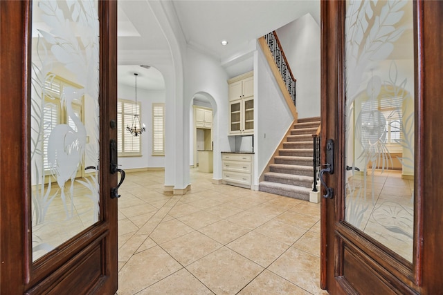 16610 Champagne Falls Ct, Spring, TX 77379 - entrance foyer featuring stairs, baseboards, arched walkways, french doors, and ornamental molding