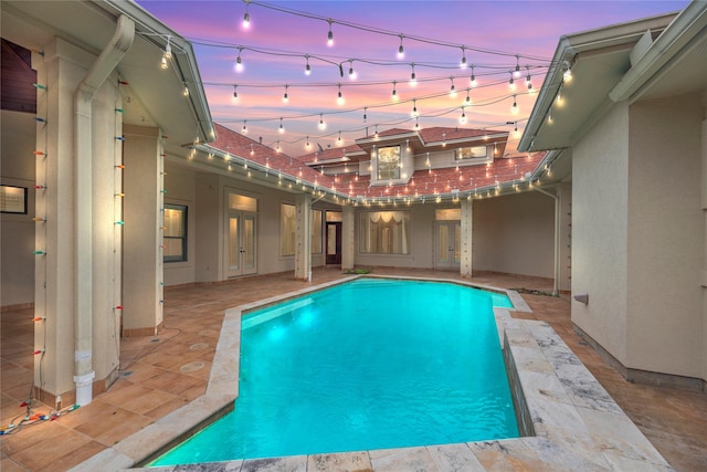 16610 Champagne Falls Ct, Spring, TX 77379 - pool at dusk featuring an outdoor pool and a patio area