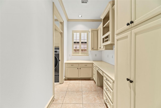 16610 Champagne Falls Ct, Spring, TX 77379 - kitchen with cream cabinetry, light tile patterned floors, light countertops, open shelves, and washer / dryer