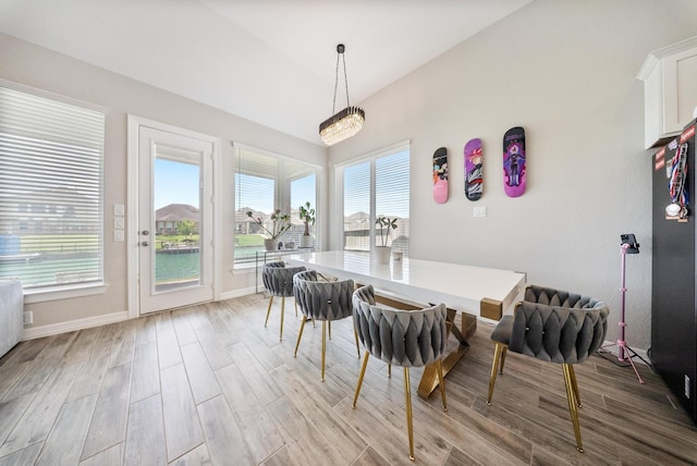 24103 Corinaldo Ct, Katy, TX 77493 - dining area featuring light wood-style flooring, lofted ceiling, and baseboards