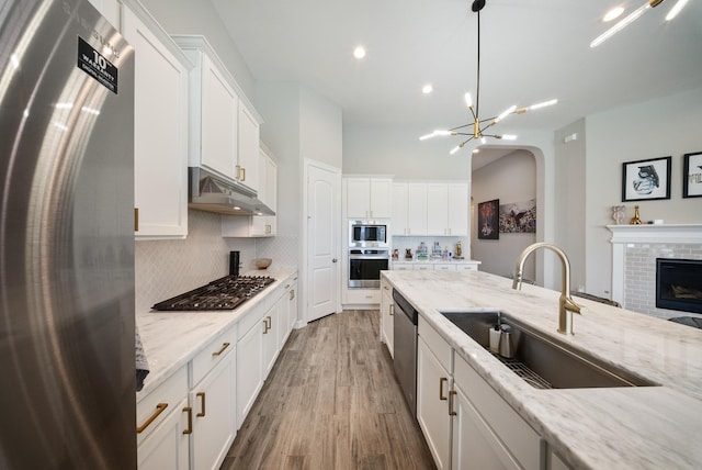 24103 Corinaldo Ct, Katy, TX 77493 - kitchen with stainless steel appliances, under cabinet range hood, a sink, tasteful backsplash, and recessed lighting