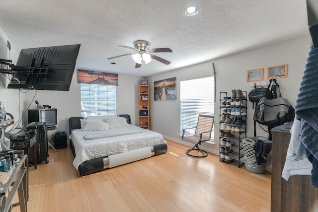 14811 S Bristol Harbour Cir, Houston, TX 77084 - bedroom with a textured ceiling, wood finished floors, baseboards, and a ceiling fan