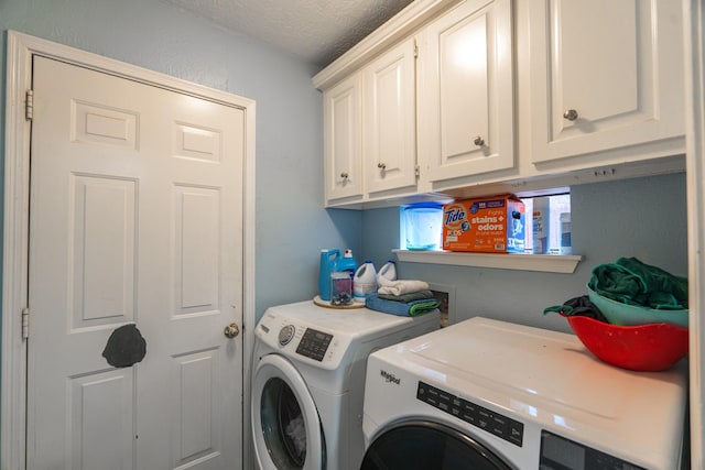 14811 S Bristol Harbour Cir, Houston, TX 77084 - laundry room featuring washing machine and clothes dryer, cabinet space, and a textured ceiling