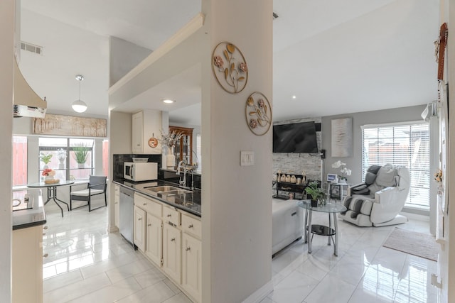 14811 S Bristol Harbour Cir, Houston, TX 77084 - kitchen with white microwave, a sink, dark countertops, stainless steel dishwasher, and open floor plan