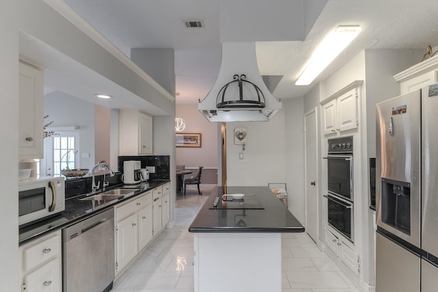 14811 S Bristol Harbour Cir, Houston, TX 77084 - kitchen with black appliances, a sink, dark countertops, light marble finish flooring, and a center island