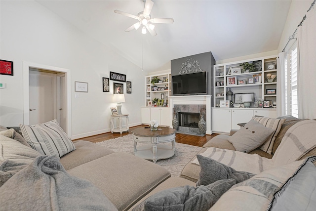 914 W 25th St Unit 2, Houston, TX 77008 - living area featuring a ceiling fan, wood finished floors, a fireplace, baseboards, and high vaulted ceiling