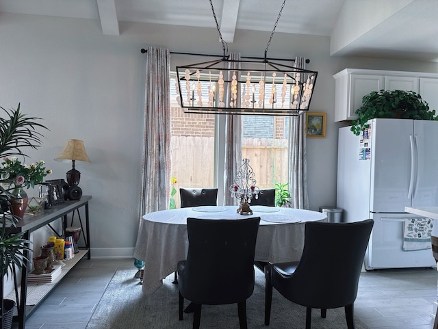 31414 Golden Cliffs Ln, Fulshear, TX 77441 - dining space featuring a chandelier, wood finished floors, and baseboards