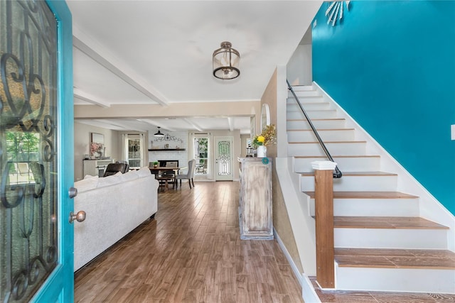 676 Ravensworth Dr, Conroe, TX 77302 - entrance foyer with wood finished floors, beamed ceiling, stairway, and a fireplace