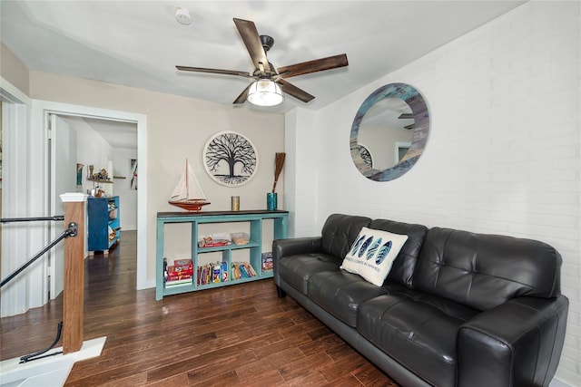 676 Ravensworth Dr, Conroe, TX 77302 - living room featuring wood finished floors, a ceiling fan, brick wall, and baseboards